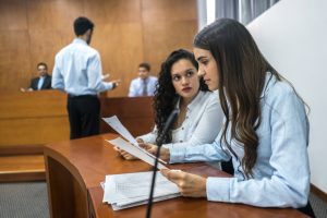 A couple of female lawyers on trial at the courthouse are going through the disclosure process investigating the materials